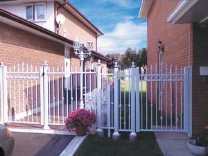 White Aluminum Gate And Fence Leading Into Backyard